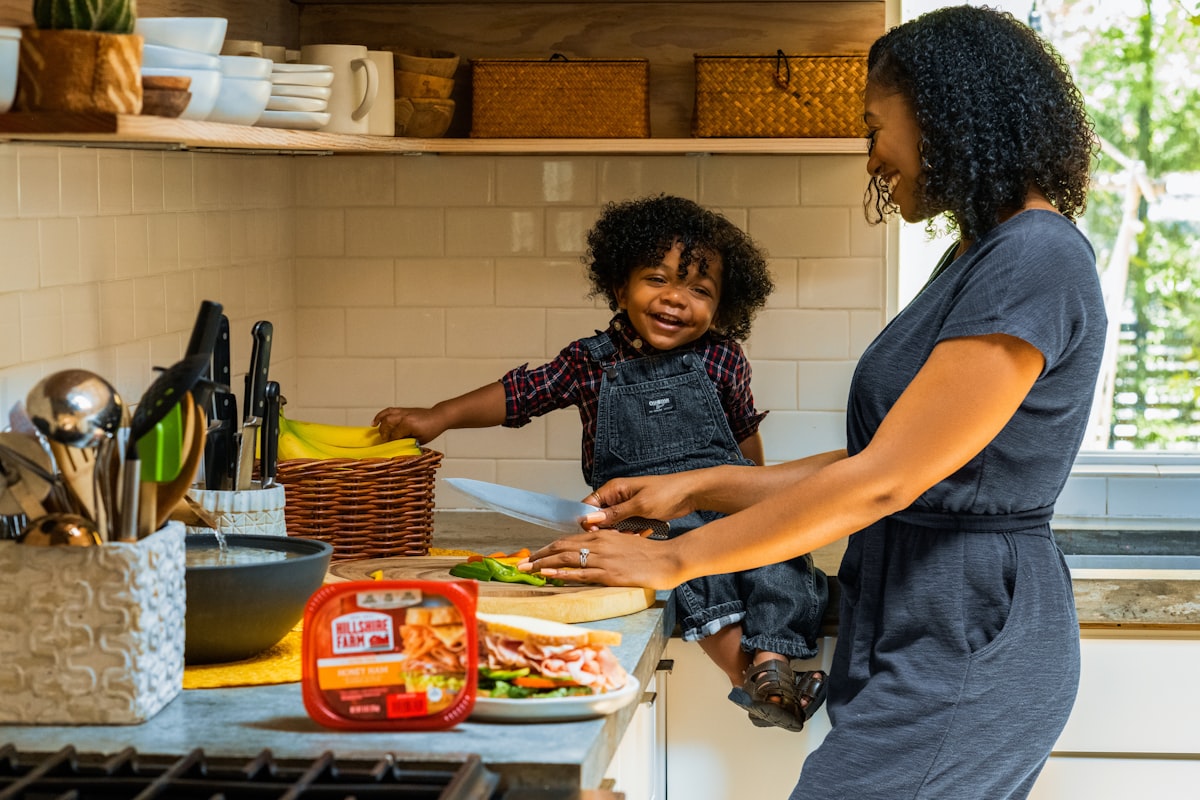 Parent and child cooking together in a modern kitchen